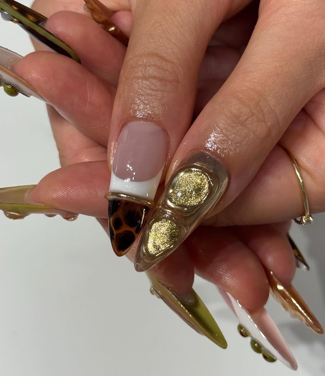 Olive Gold Abstract Sculpted Stiletto Nails with Glossy Pearl and Tortoise Details