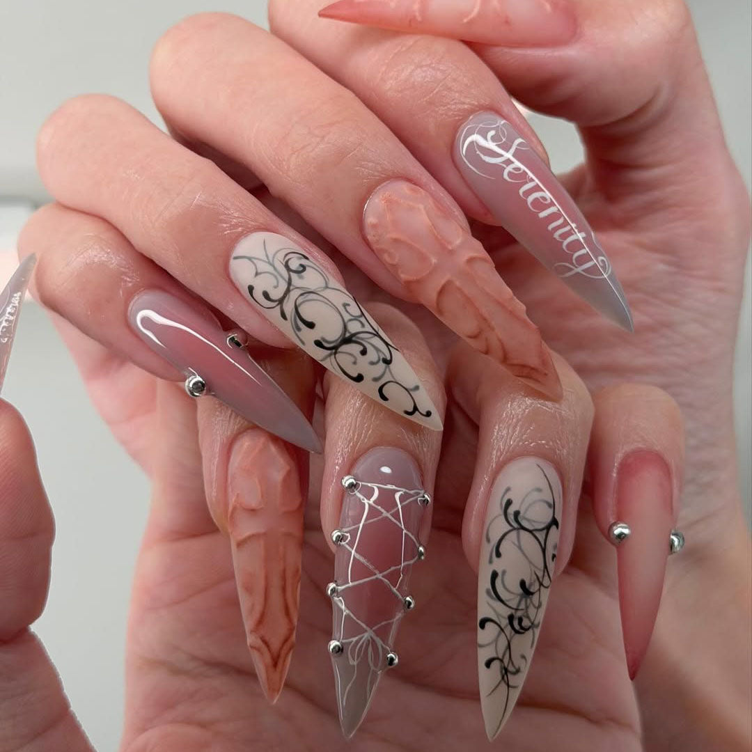Ethereal Serenity Nude and Gray Stiletto Nails with Baroque Script and 3D Cross Design