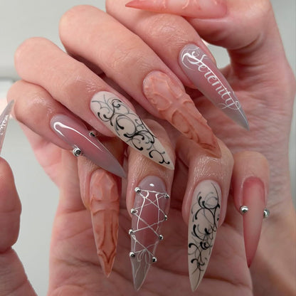 Ethereal Serenity Nude and Gray Stiletto Nails with Baroque Script and 3D Cross Design